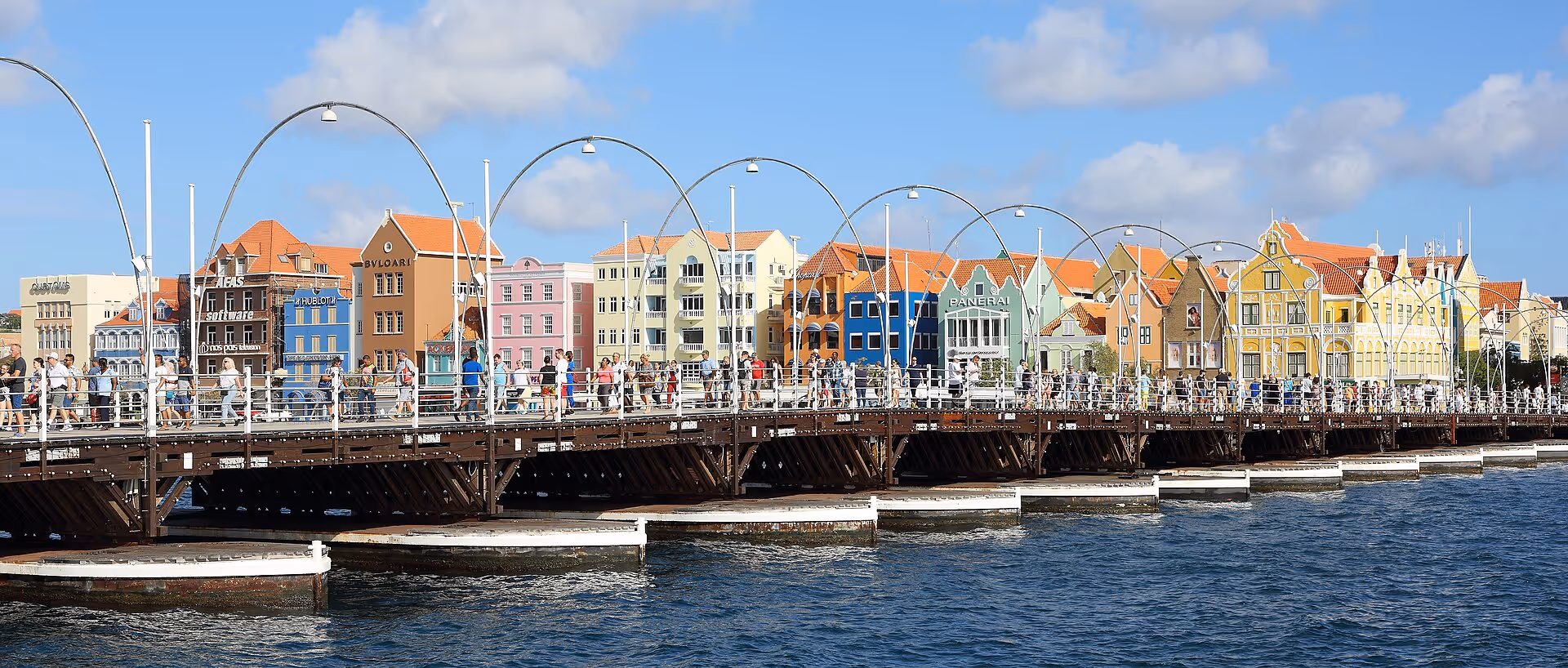 The painted facades of the Handelskade with the Queen Emma pontoon bridge in the foreground, Willemstad