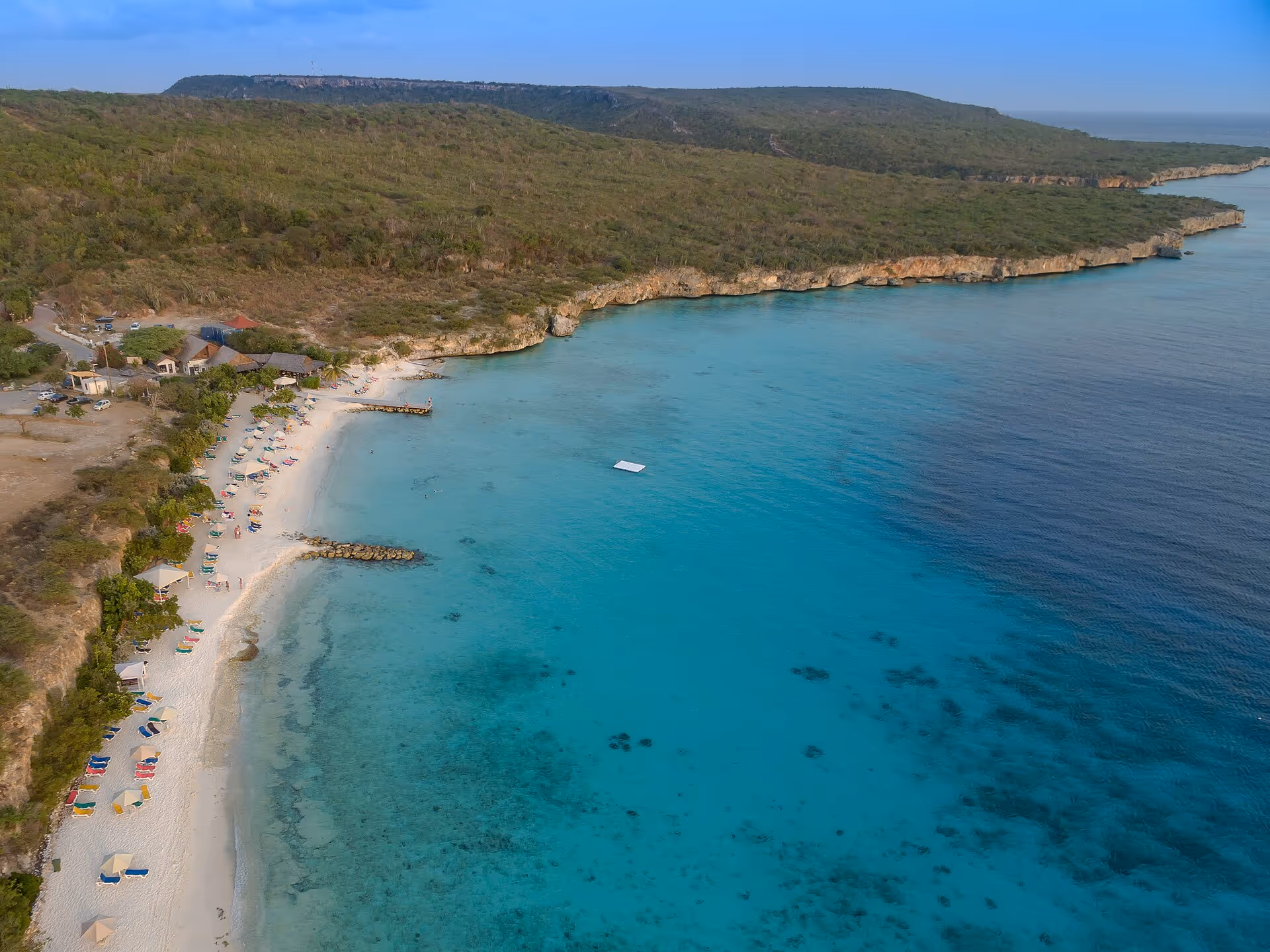 Aerial view of the full Porto Mari bay with the beach bar and rows of loungers